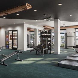 fitness center with open spaces and bright lighting through the windows